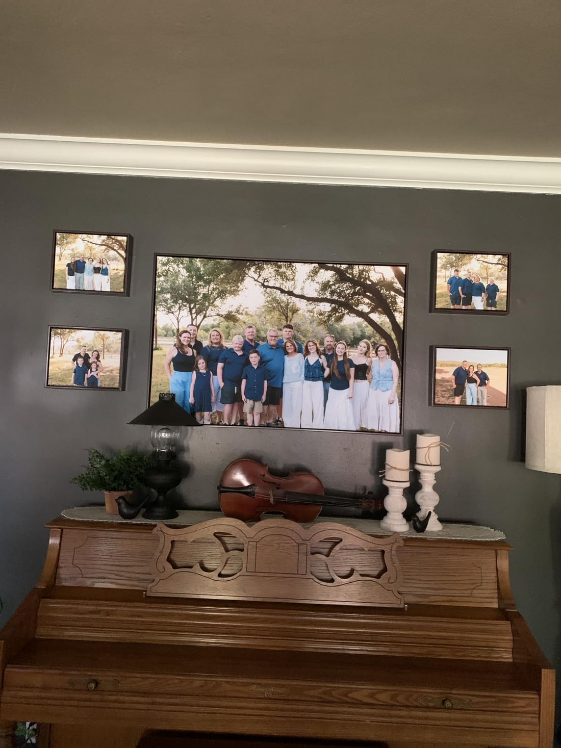 Family photo gallery wall with a large custom family canvas above a piano