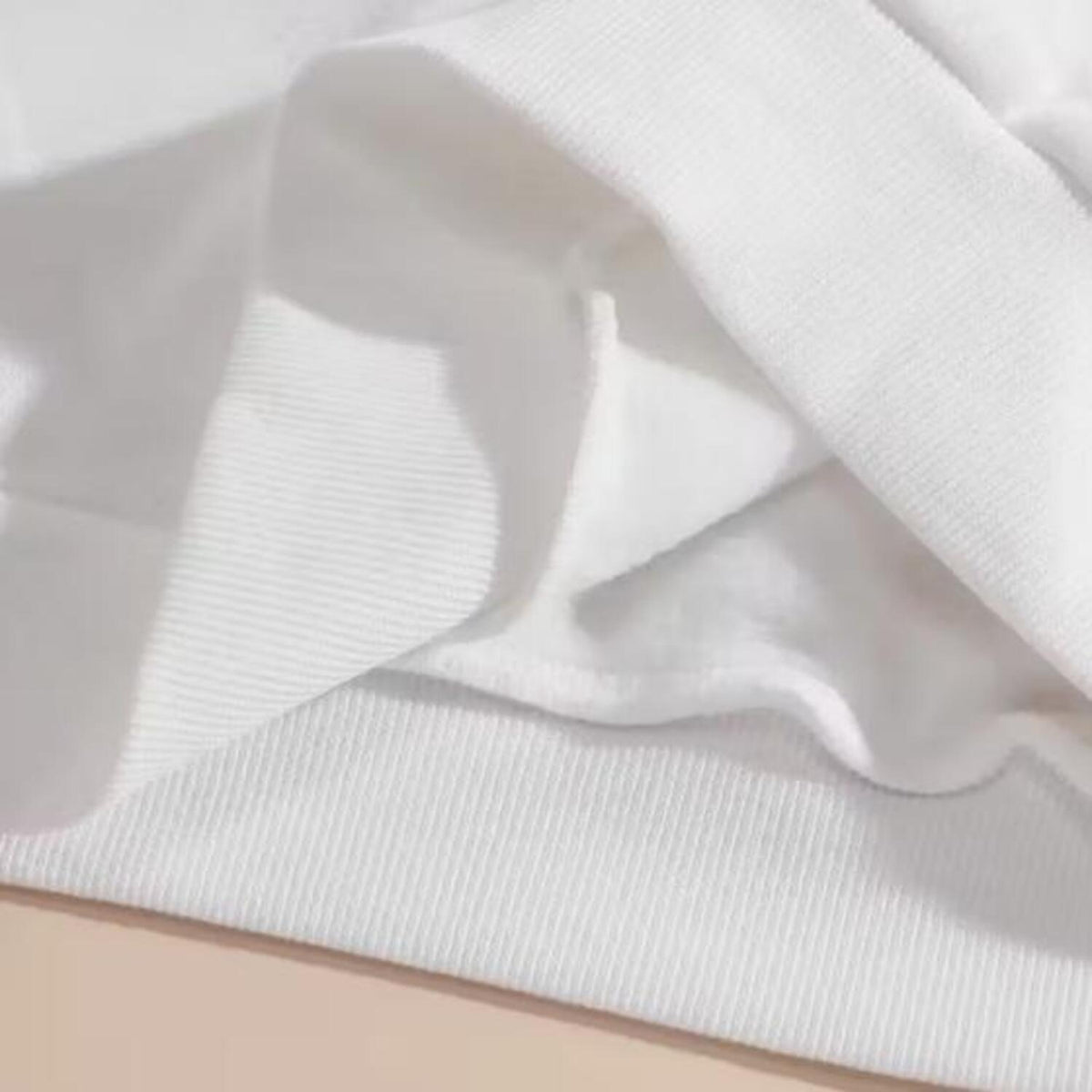 Close-up of white long sleeve shirt fabric and ribbed cuff