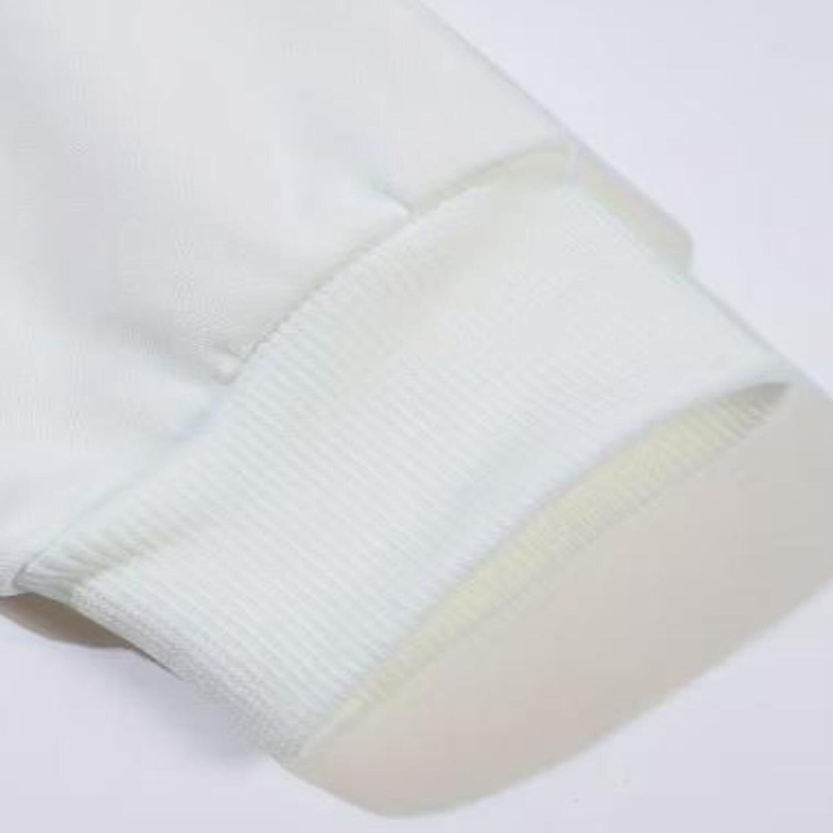 White long sleeve shirt ribbed sleeve cuff and seam close-up