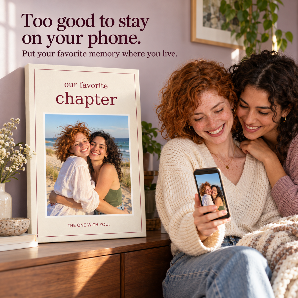 Two women enjoying their beach memory on a phone and an Our Favorite Chapter photo canvas; illustrative lifestyle mockup.